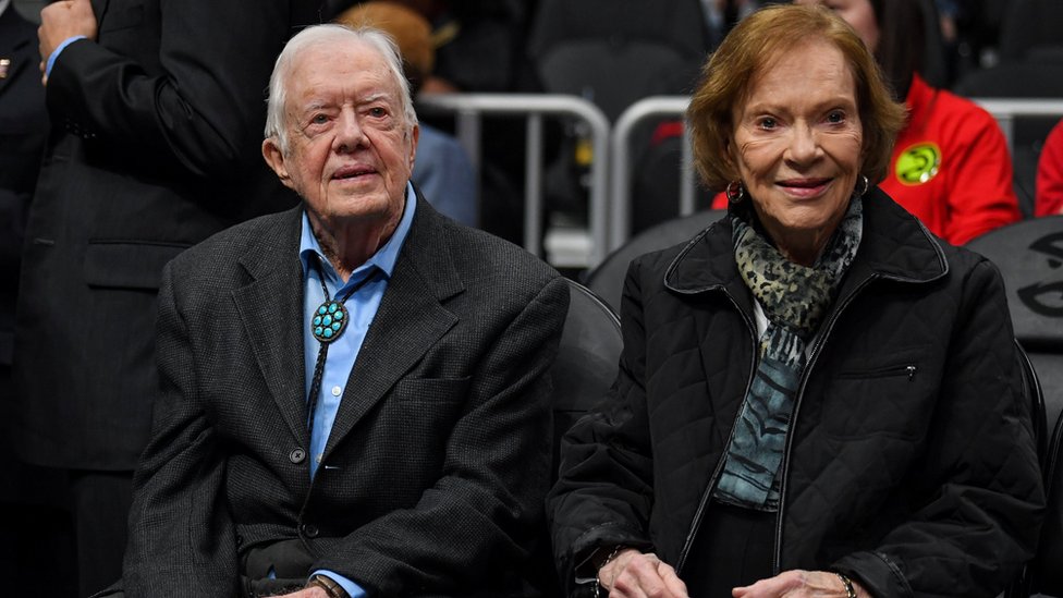 Former US President Jimmy Carter and his wife Rosalynn Carter attend at the game between the Atlanta Hawks and the New York Knicks at State Farm Arena.