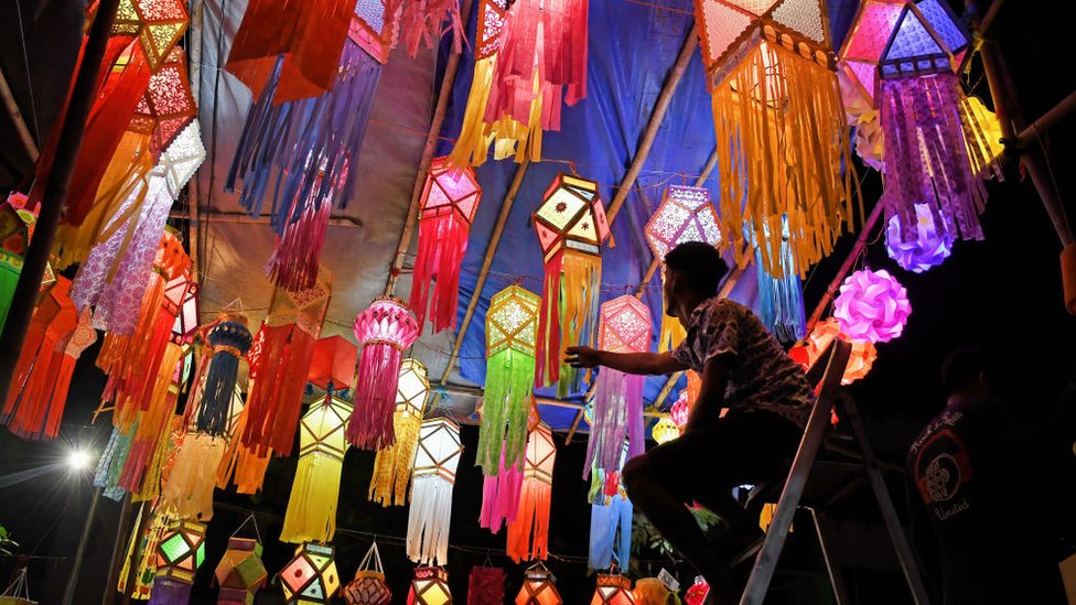 MUMBAI, MAHARASHTRA, INDIA - 2023/11/08: A shopkeeper arranges lanterns kept for sale ahead of the Diwali festival, the Hindu festival of lights in Mumbai. Diwali festival is celebrated by Hindus where they shop for lanterns ahead of the festival, clean their home, prepare sweets and snacks, make rangoli (a traditional Indian art form where various designs are made on the floor), and light their homes with earthen lamps marking the victory of light over darkness. (Photo by Ashish Vaishnav/SOPA Images/LightRocket via Getty Images)