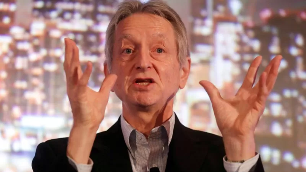 Geoffrey Hinton speaking with his hands held up in the air