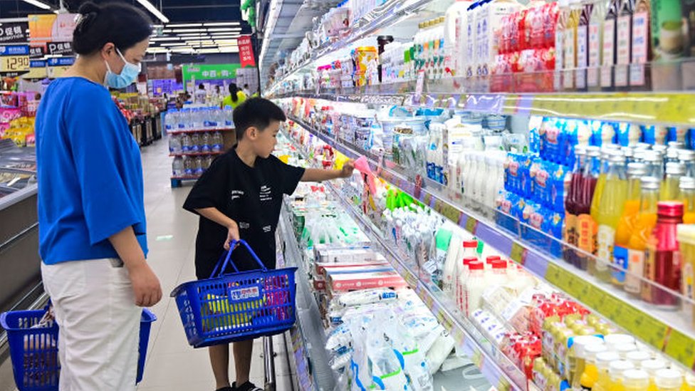 Customers shop at a supermarket in Qingzhou, East China's Shandong province, 10 July, 2023.