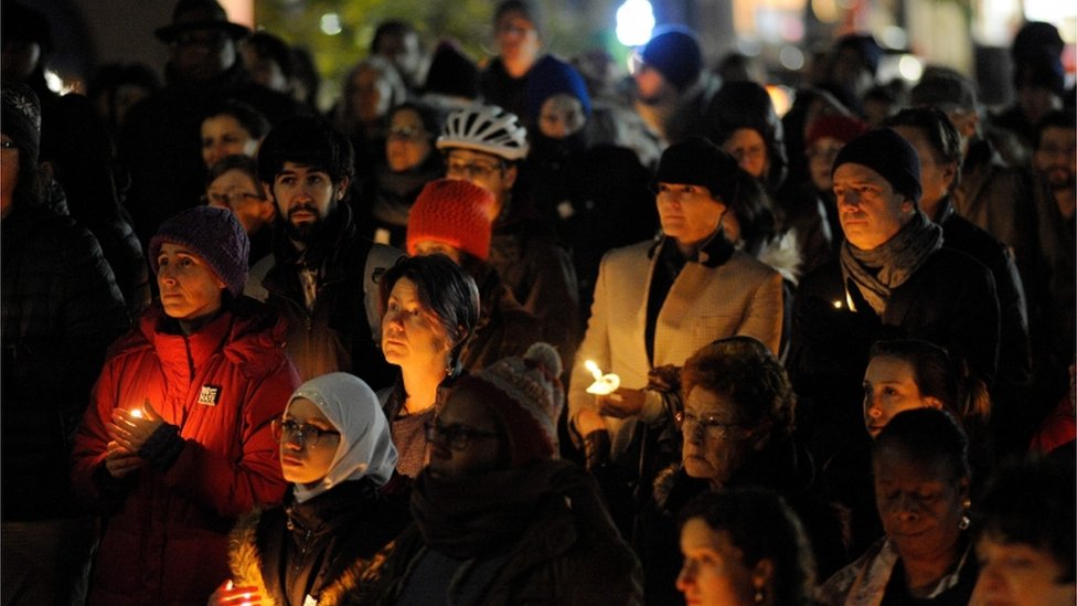Community members hold candles at a vigil for the victims of the Pittsburgh Synagogue shooting at Cambridge City Hall in Cambridge, Massachusetts