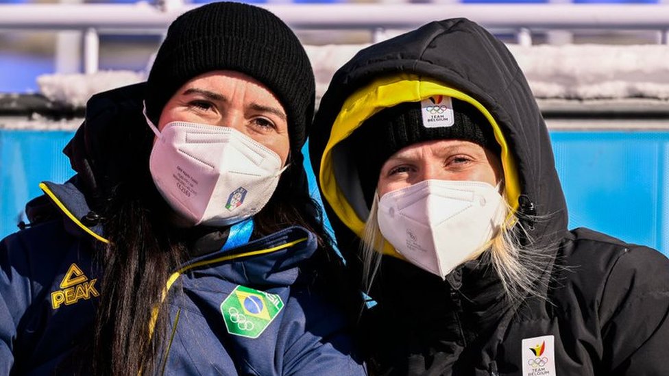 Brazil's Nicole Silveira (left) poses with her partner Kim Meylemans during the women's skeleton competition at the Beijing Games