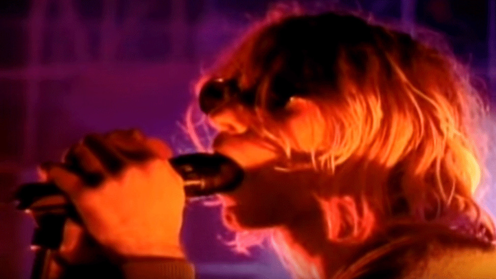 Kurt Cobain seems to eat the microphone on Top of the Pops