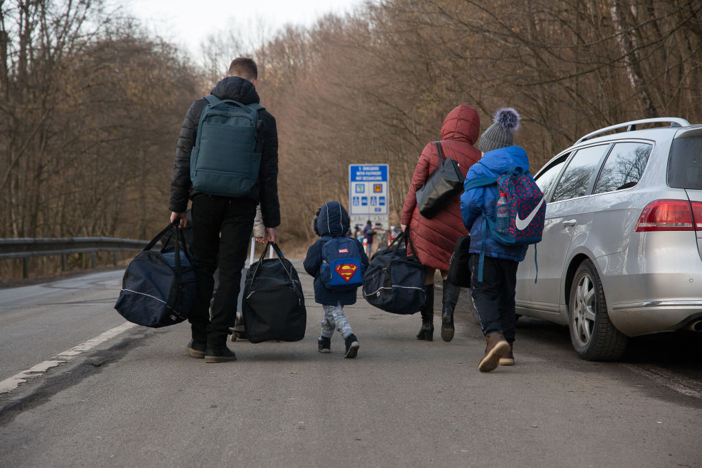 Ukrainians walking across the border into Slovakia