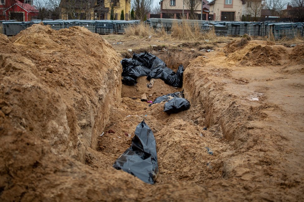 A mass gave on the grounds of a church in Bucha, where bodies were discovered when the Russians retreated