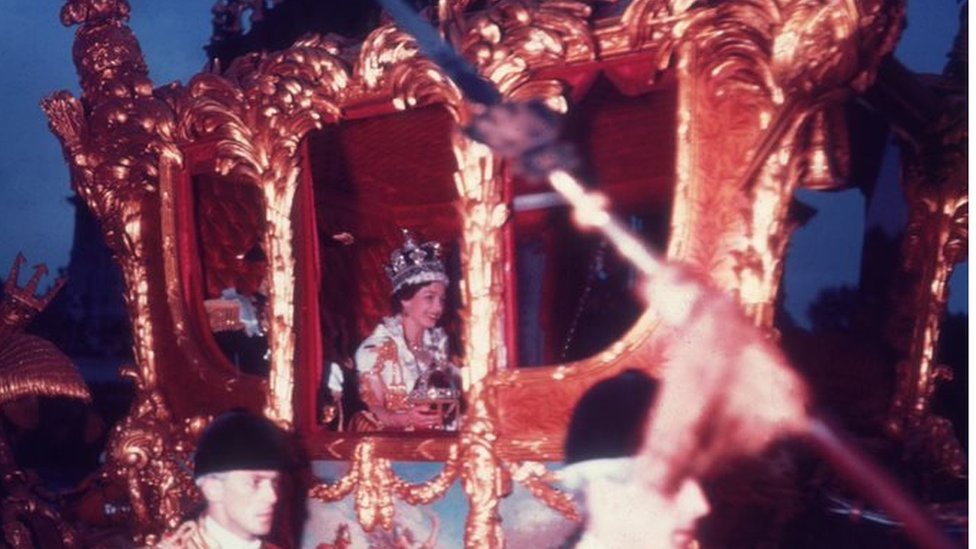 Queen Elizabeth II in a golden carriage following her coronation in June 1953