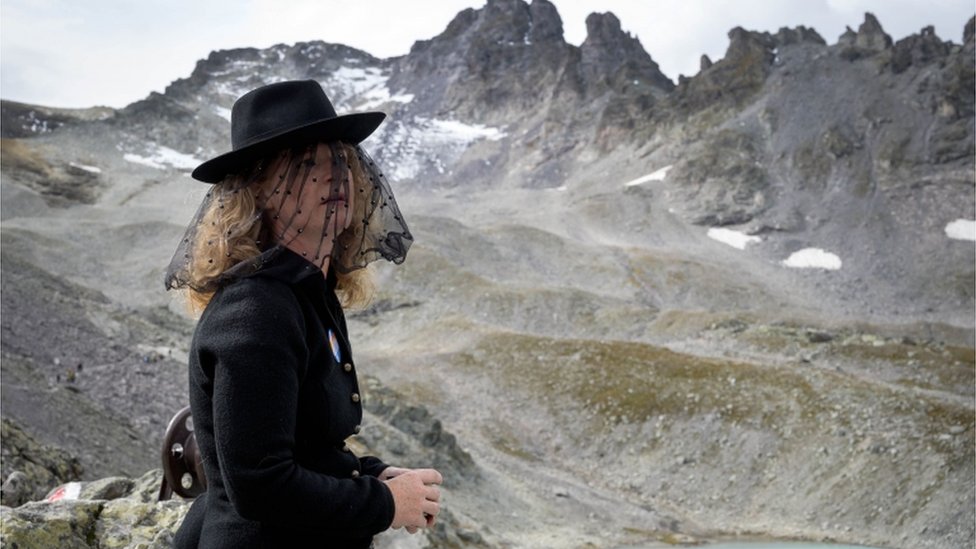 Женщина принимает участие в церемонии, посвященной «гибели» ледника Пизол