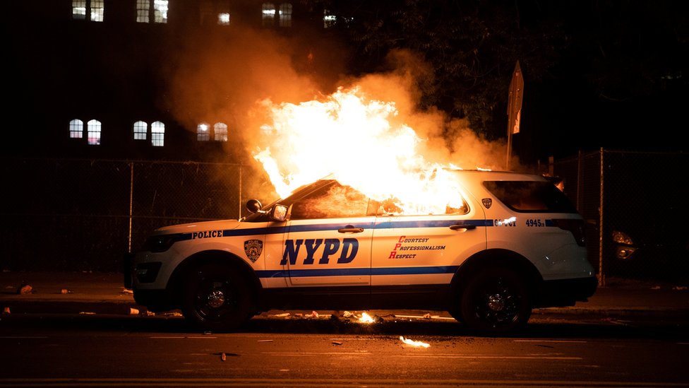 A NYPD police car is set on fire as protesters clash with police during a march against the death in Minneapolis police custody of George Floyd, in the Brooklyn borough of New York City, U.S., May 30, 2020