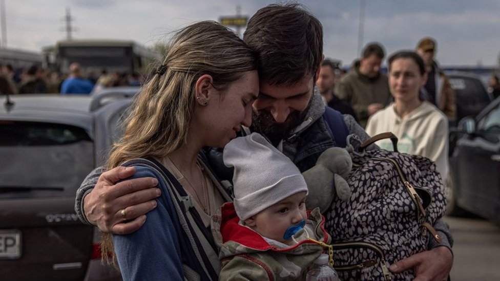 A family embrace at the evacuation point in Zaporizhzhia, Ukraine