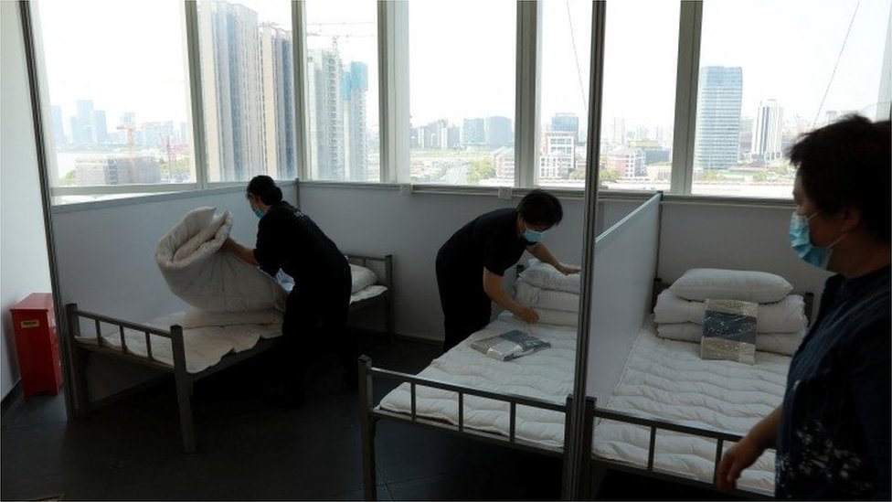 Workers make beds at a 17-storey office building to convert it into a makeshift hospital for the coronavirus disease (COVID-19), in Shanghai, China April 12, 2022
