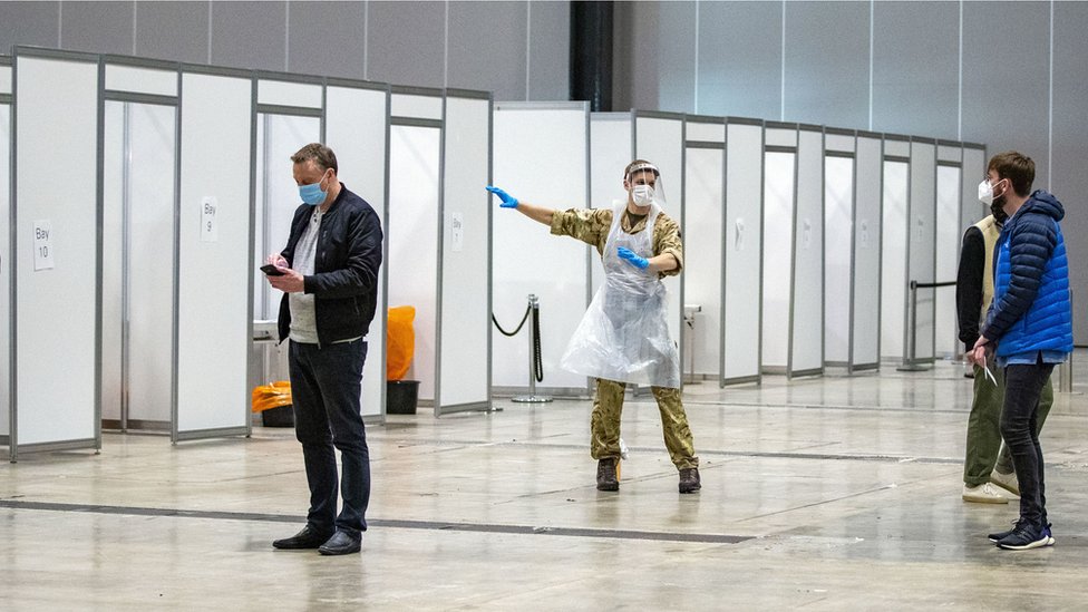 Soldier directs people at a testing centre in Liverpool