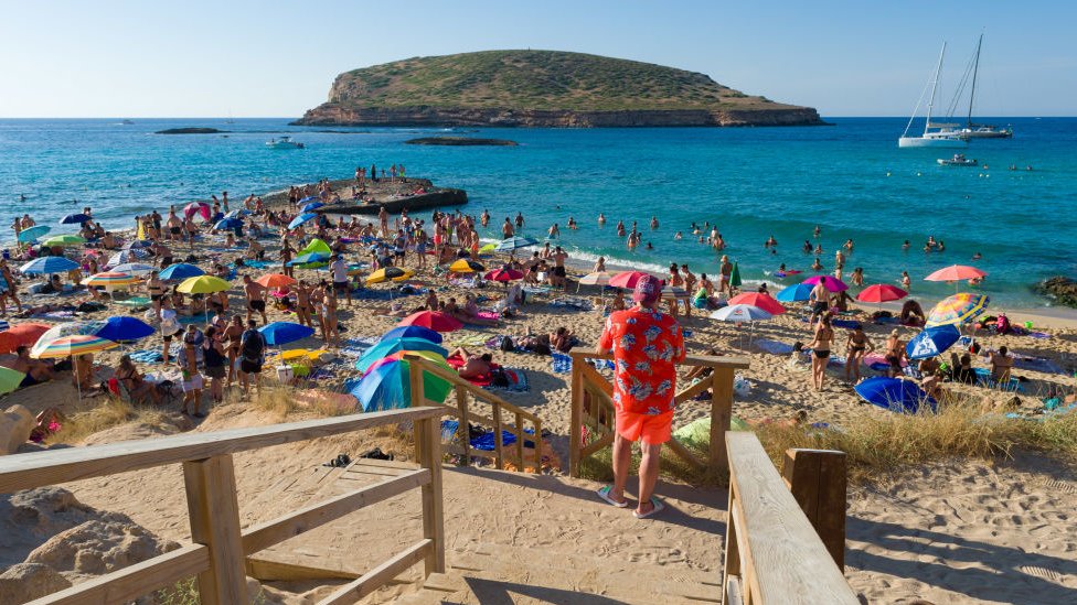 Tourists on a beach in Ibiza