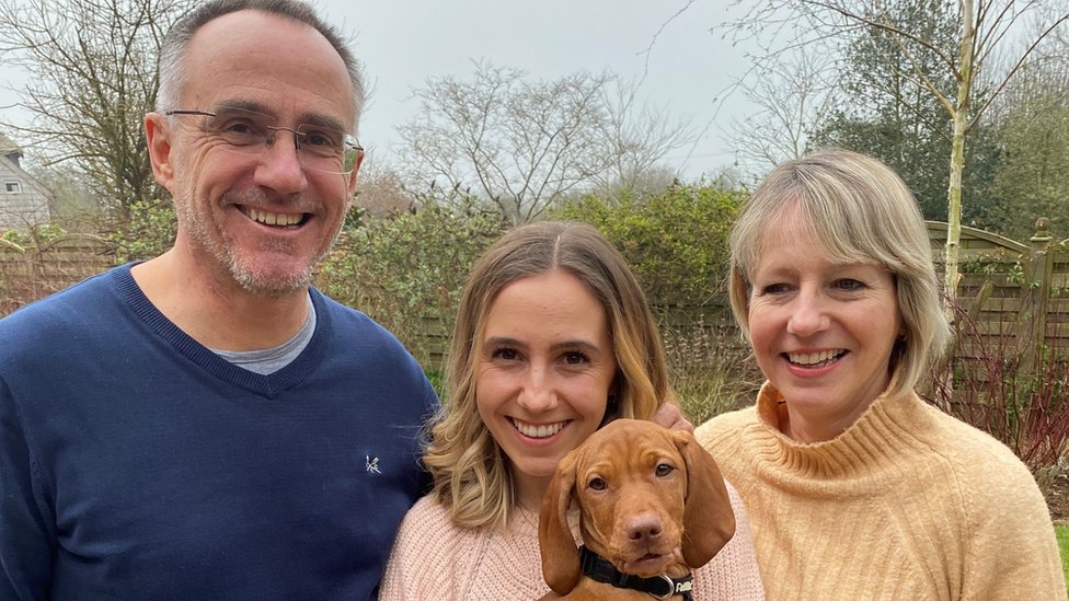 Mark Simmonds pictured with daughter Emily holding dog Peggy, and wife and business partner Mel, 57.