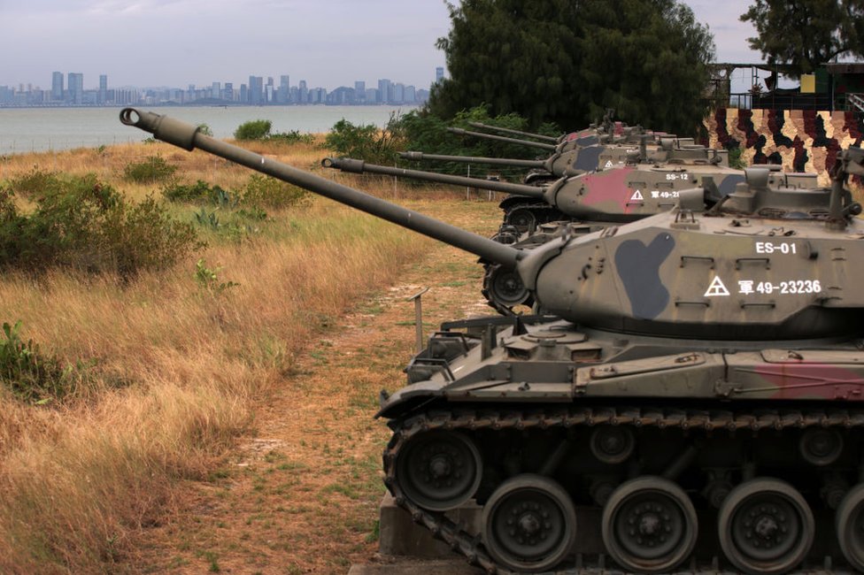 As the city of Xiamen, China, is seen in the background, retired M41 「Walker Bulldog」 light tanks, which had served the Taiwanese Army for 63 years, are on display by a beach on October 7, 2023 in Kinmen, Taiwan.