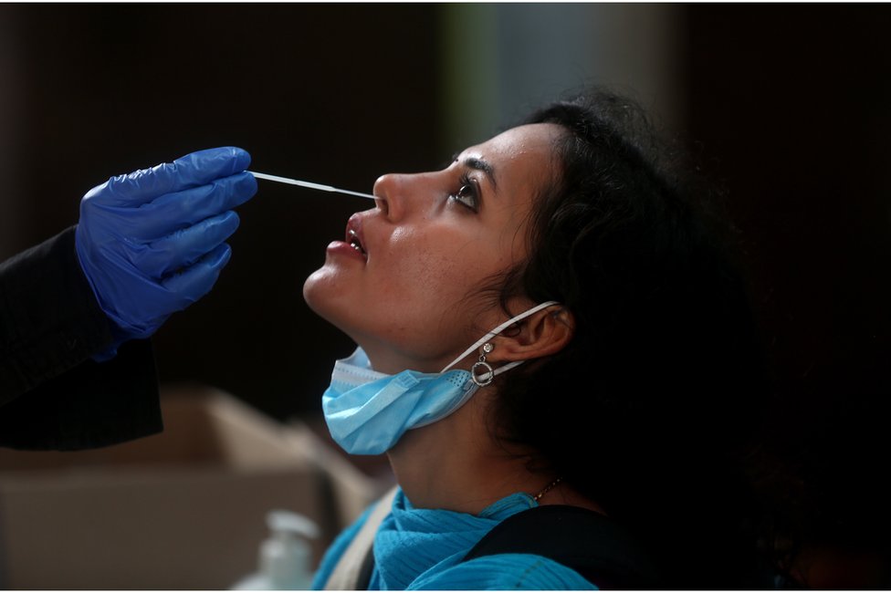 Woman undergoing a test to detect covid in India.