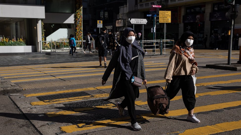 People wear face masks in Tsim Sha Tsui, in Hong Kong, China, 08 December 2021. According to an online survey by the Society of Hospital Pharmacists of Hong Kong, nearly half of unvaccinated Hongkongers say they will not be getting inoculated against Covid-19
