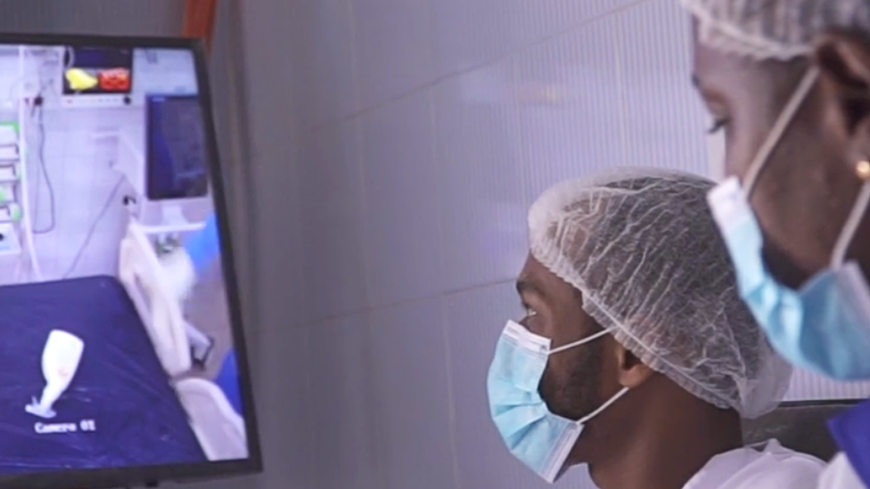 Medics looking at a monitor showing a patient with coronavirus at Fann Hospital in Senegal