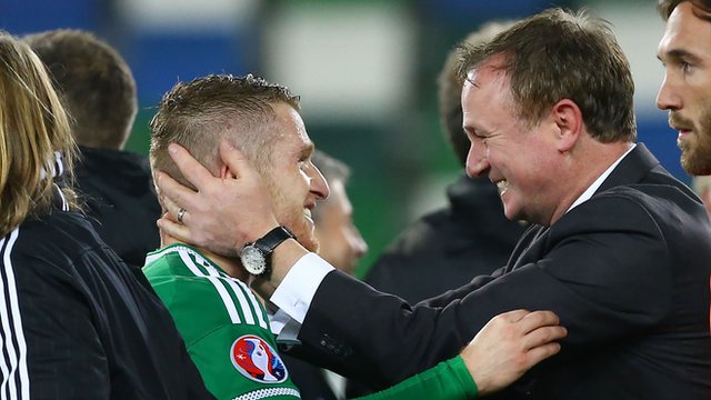Northern Ireland manager Michael O'Neill embraces skipper Steven Davis after the team's qualification for Euro 2016