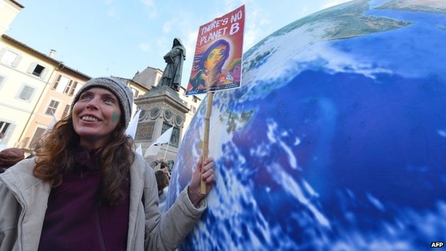 Woman holding poster reading 'There is no Planet B'