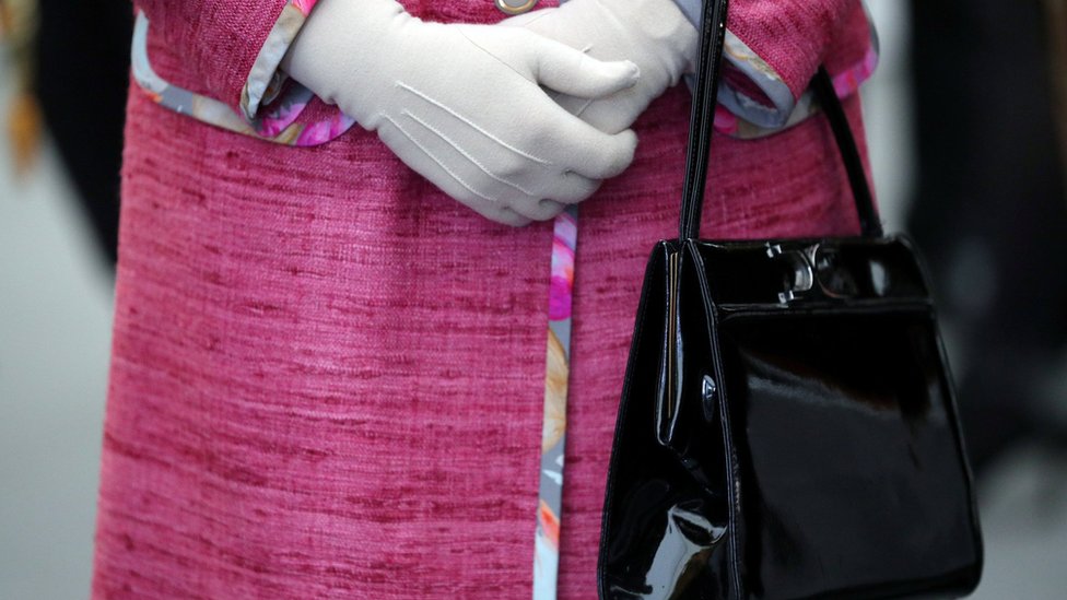 The Queen in pink with a Launer bag