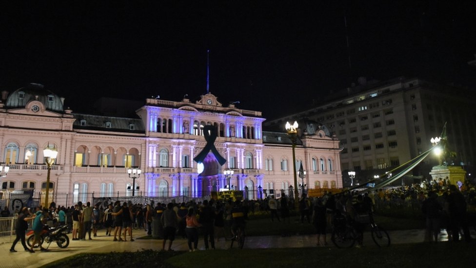 People gather outside the Casa Rosada presidential palace ahead of the wake of soccer legend Diego Maradona, in Buenos Aires, Argentina