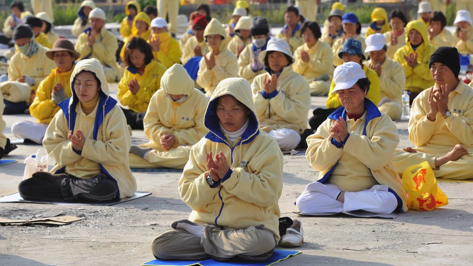 Falun Gong practitioners sit cross-legged at a demonstration in Taiwan