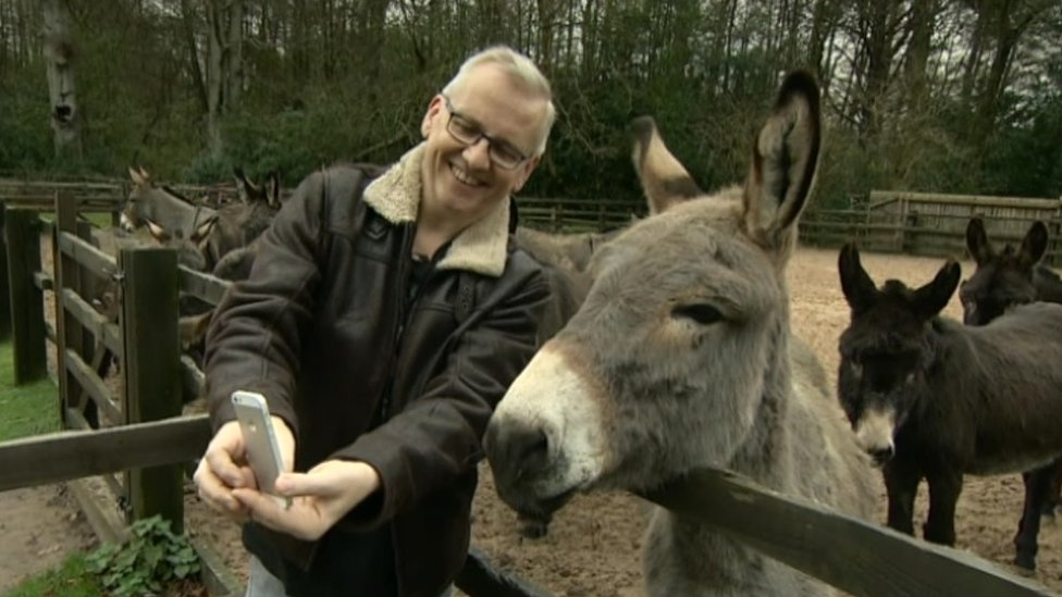 Chris Clarke takes a selfie with a donkey