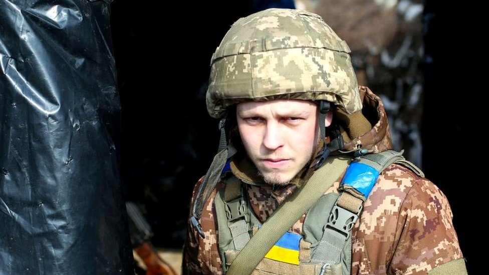A Ukrainian serviceman is seen at a position on the frontline