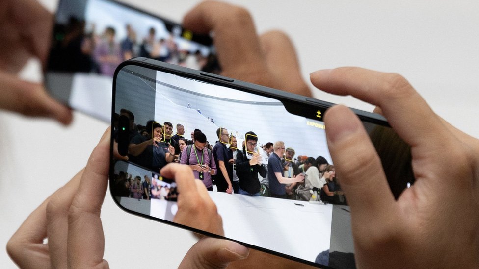 Attendees try the new iPhone 16 as Apple holds an event at the Steve Jobs Theater on its campus in Cupertino, California, U.S. September 9, 2024.