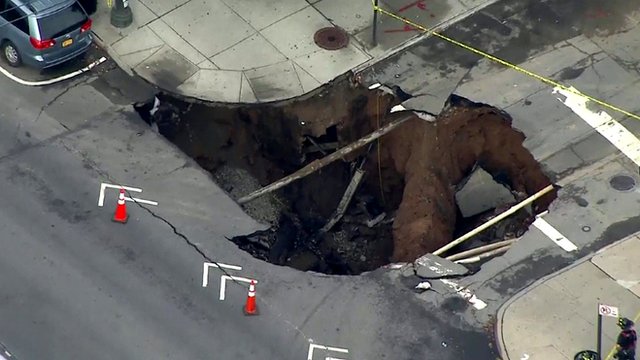 A giant sinkhole opens up a residential street in the New York neighbourhood of Brooklyn