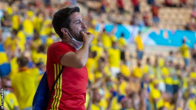 Spain fan whistles in the stands in Seville
