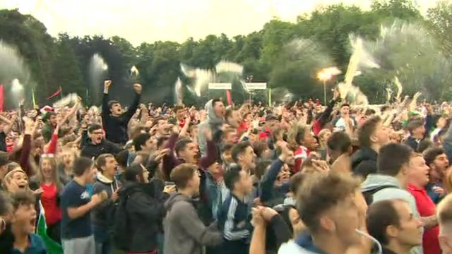 Supporters in the fan zone in Cooper's Field, Cardiff celebrate as Hal Robson-Kanu scores