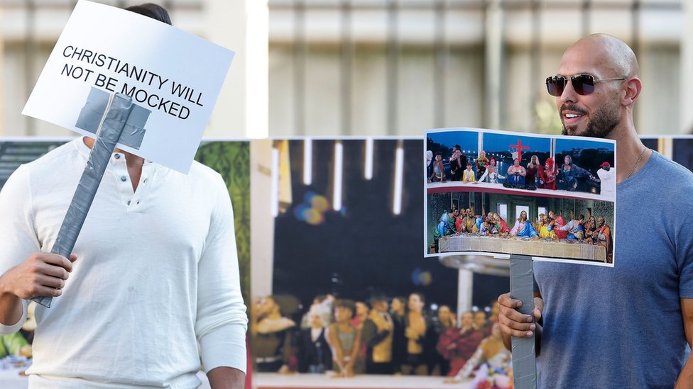 US-British former professional kickboxer and social media influencer Andrew Tate (R) and his brother Tristan (L) wave placards during a protest in front of the French embassy to show his displeasure with the opening ceremony of the 2024 Olympic Games in Paris, when 'The Last Supper' was parodied, in a segment, by a song performed by French musician Philippe Katerine, in Bucharest, Romania, 28 July 2024