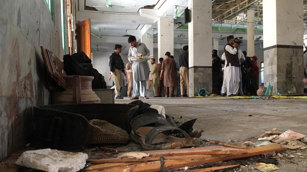 People survey the damage inside the school