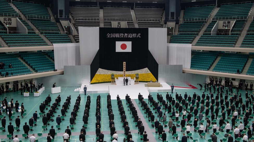 Image shows a memorial event in Tokyo