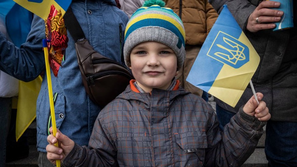 Un niño sonríe frente a la cámara en Kyiv.