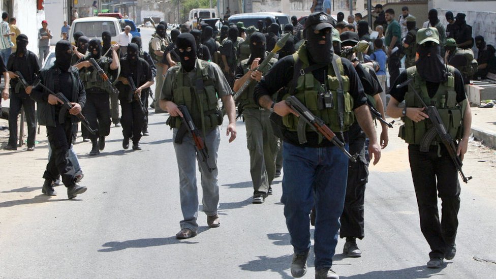 Hamas militants march towards the Palestinian Preventative Security headquarters during clashes in Gaza City on 14 June 2007