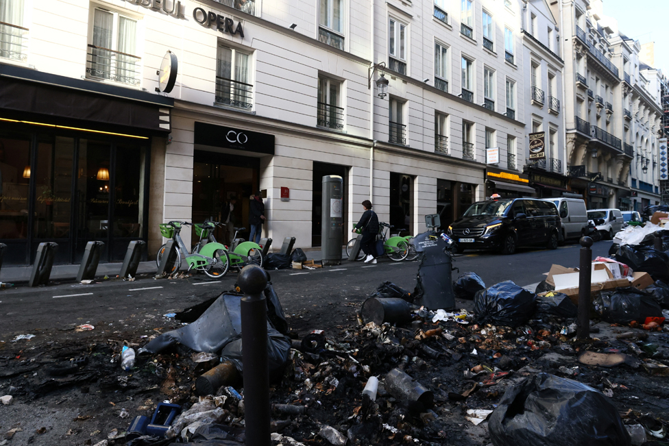 A view shows burnt rubbish and damage in a street the day after clashes during protests over French government's pension reform in Paris, France, March 24, 2023.