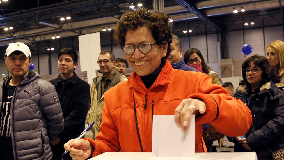 Una mujer peruana votando en España