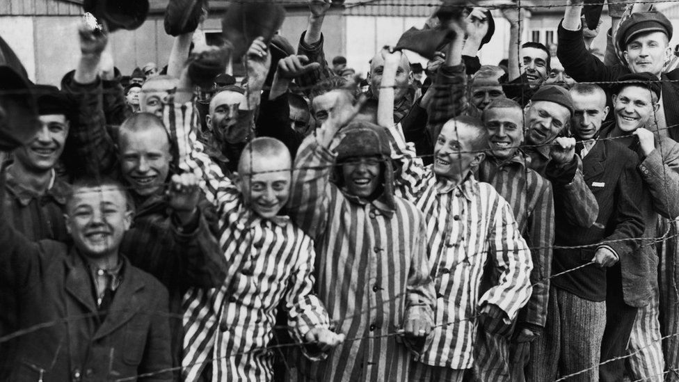 Dachau prisoners cheer soldiers who had come to free them.