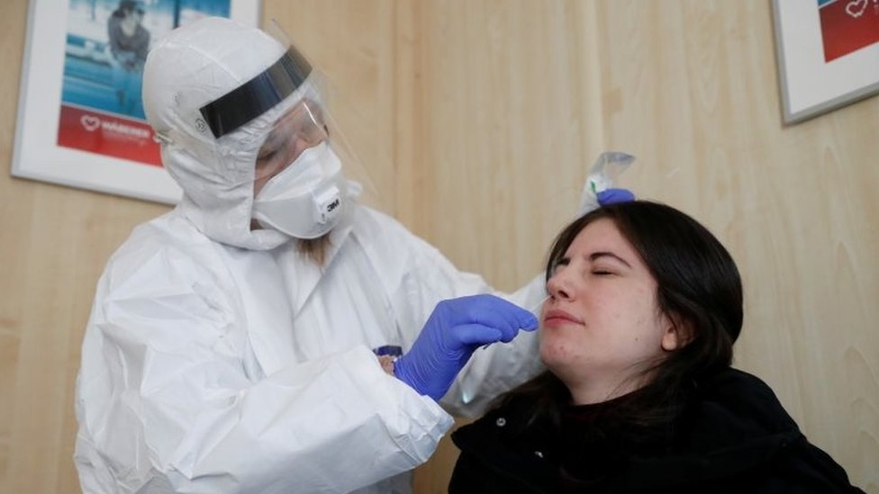 A healthcare worker collects a swab sample from a woman at a COVID-19 testing site as the spread of the coronavirus disease (COVID-19) continues in Budapest, Hungary, on 27 October 2020.