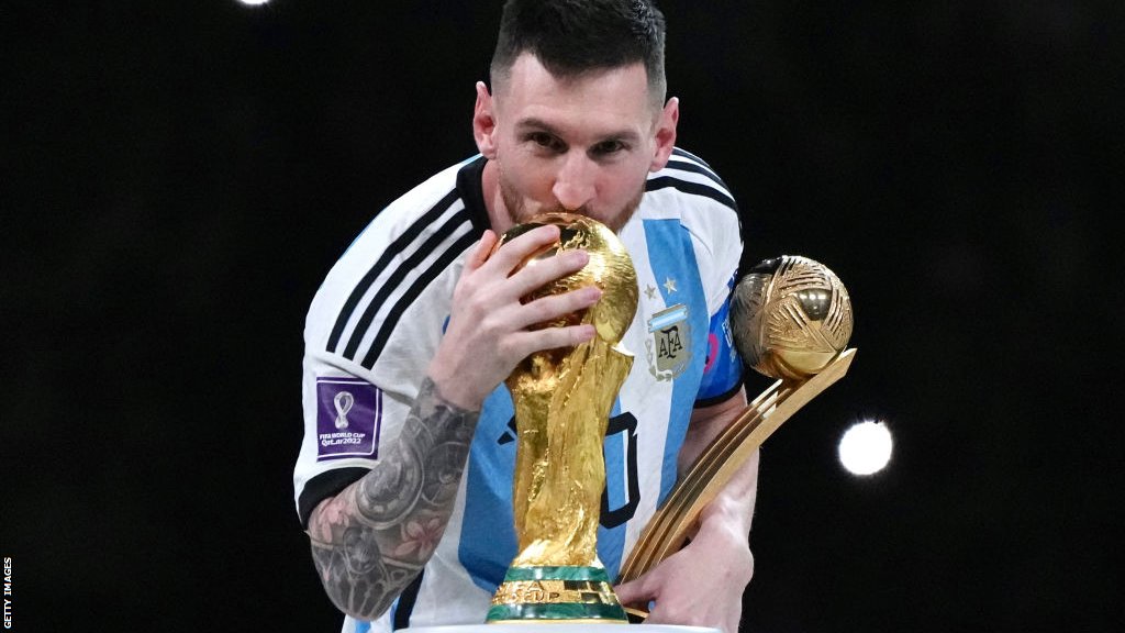 Lionel Messi kisses the World Cup trophy in Qatar