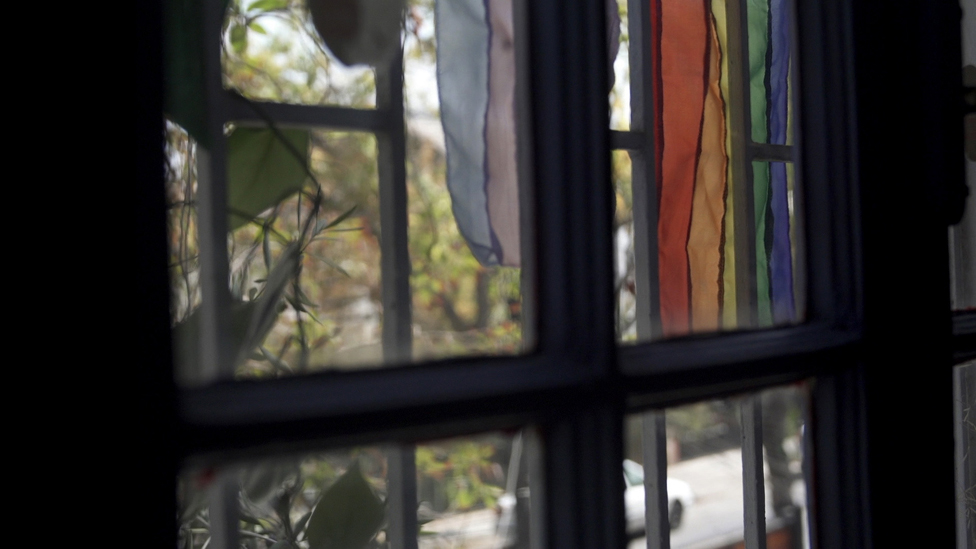 Rainbow flag in the window of Lesbians Breaking the Silence