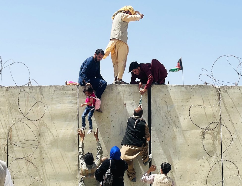 Thousands of Afghans rush to the Hamid Karzai International Airport as they try to flee the Afghan capital of Kabul, Afghanistan, on 16 August 2021