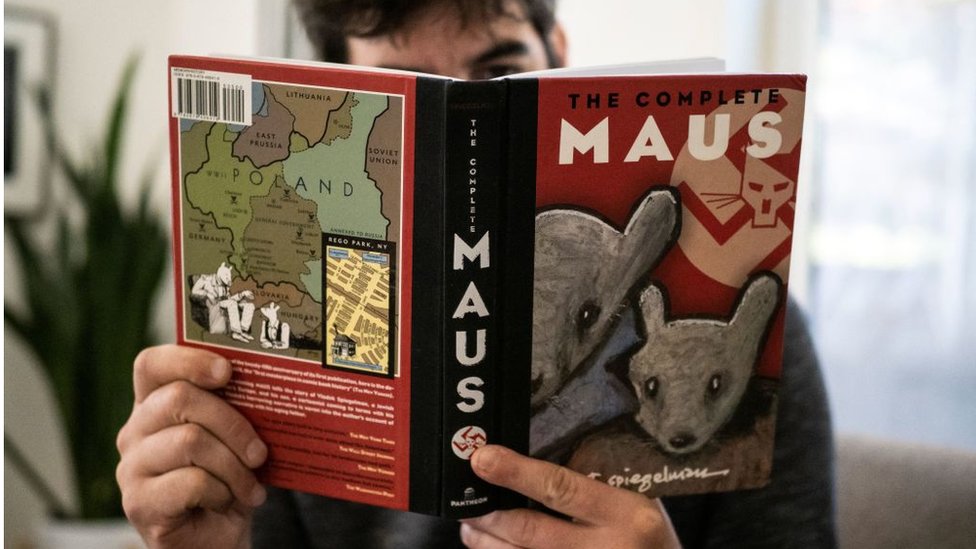 A person reading Maus