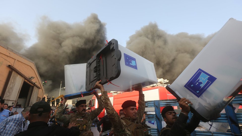 رجال الأمن يحملون صناديق الاقتراع