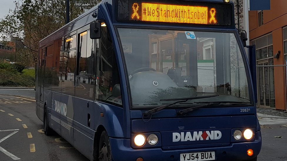 Автобус со слоганом #WeStandWithIsobel