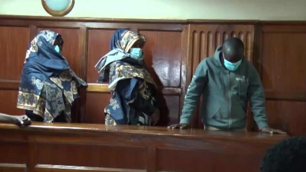 The three suspects stand in court