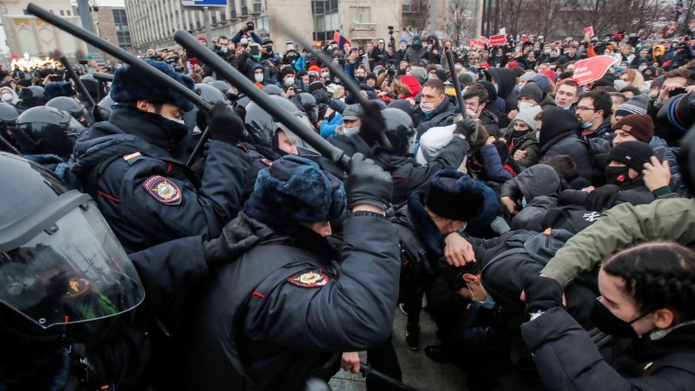 Law enforcement officers clash with participants using batons in Moscow protest