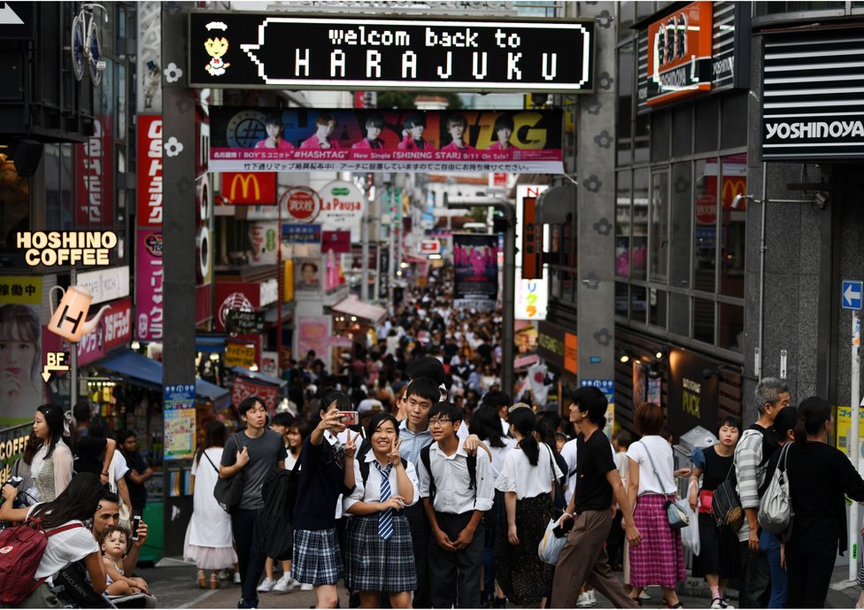 People walk in the Harajuku district of Tokyo